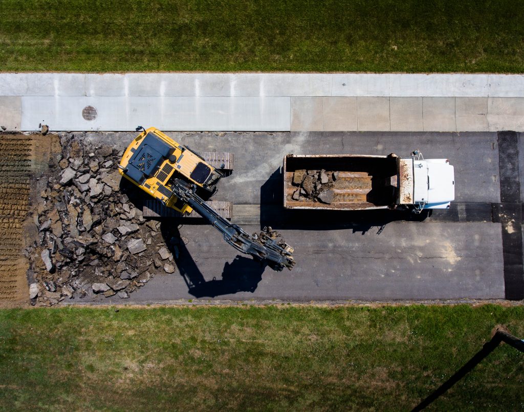 Backhoe loading a gravel truck